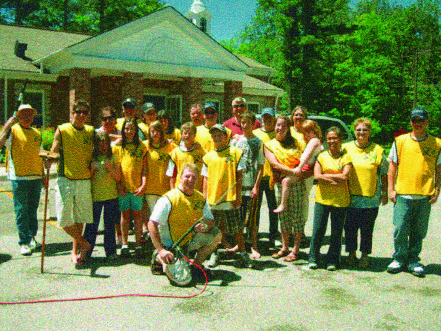 group of people wearing yellow shirts