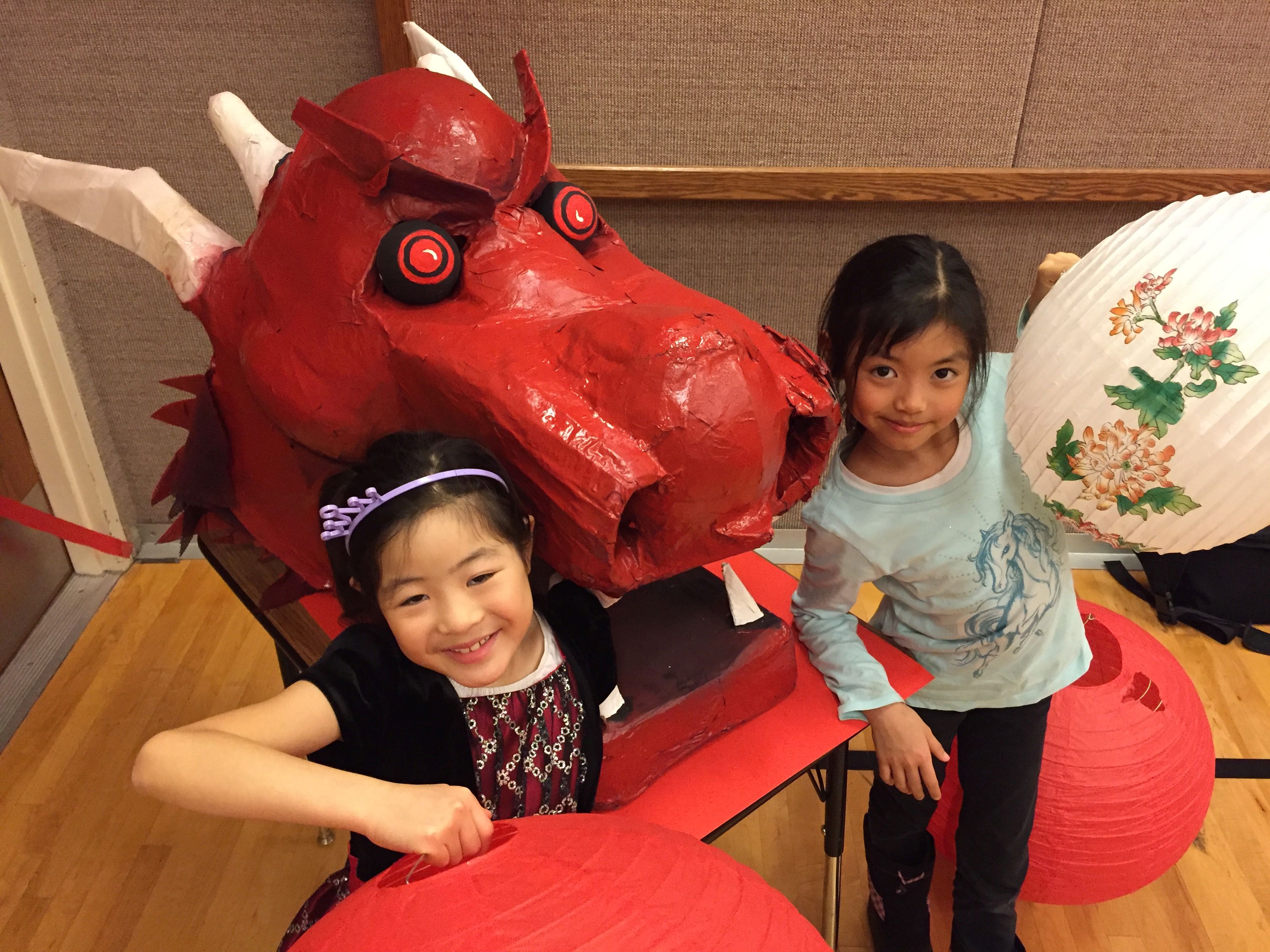 two little girls with a red dragon