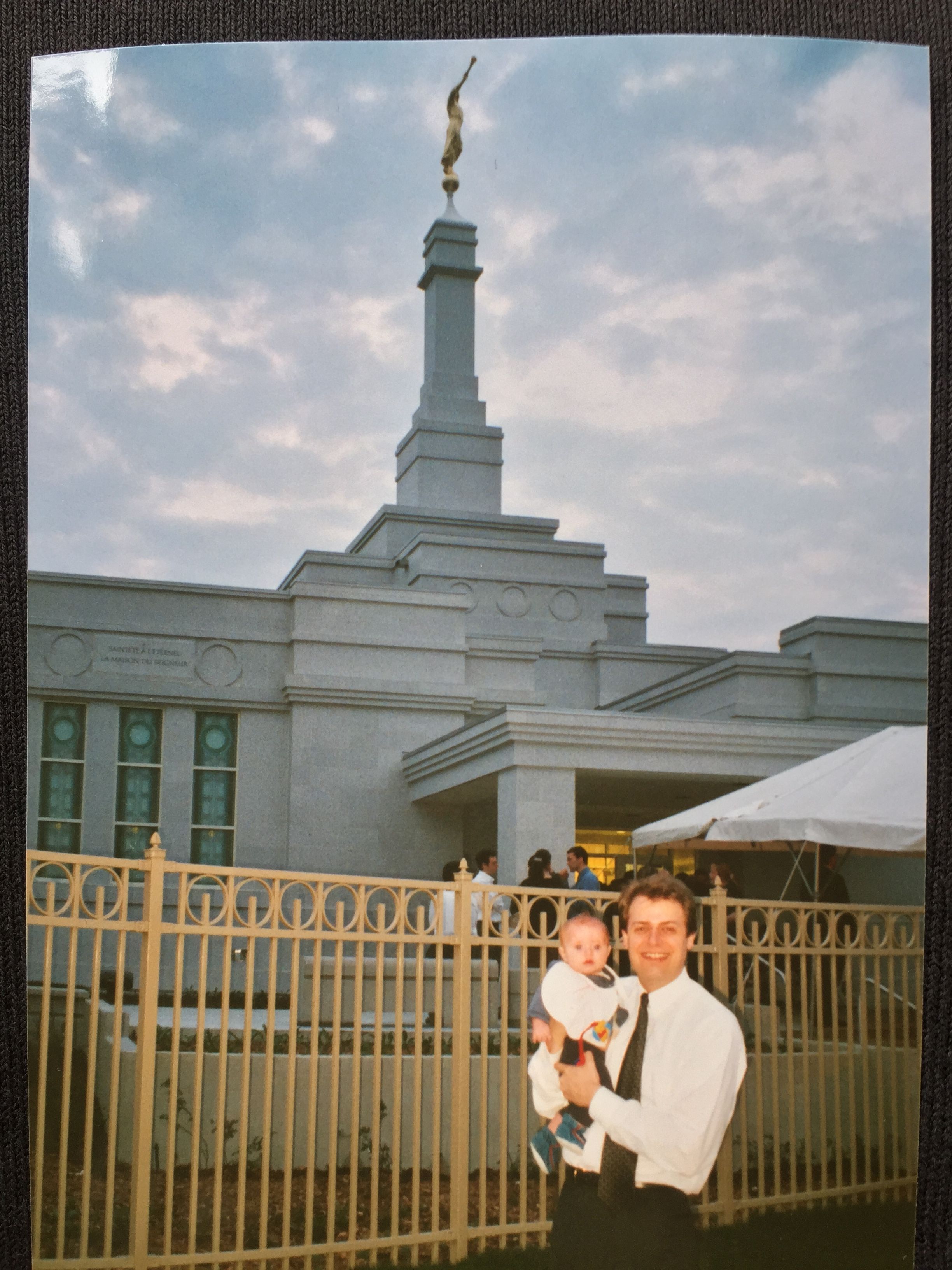 father and a baby in front of the temple