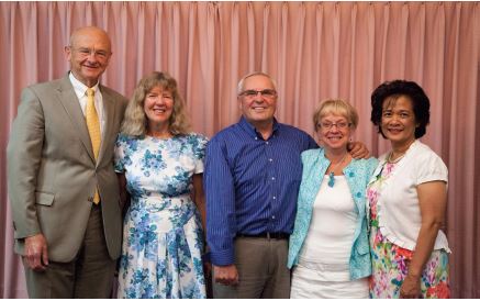 four people standing together