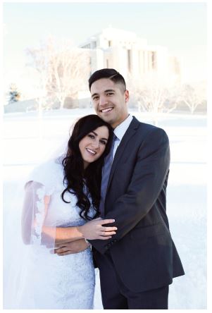 husband and wife in front of the temple