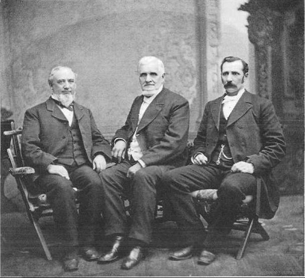 three men sitting together