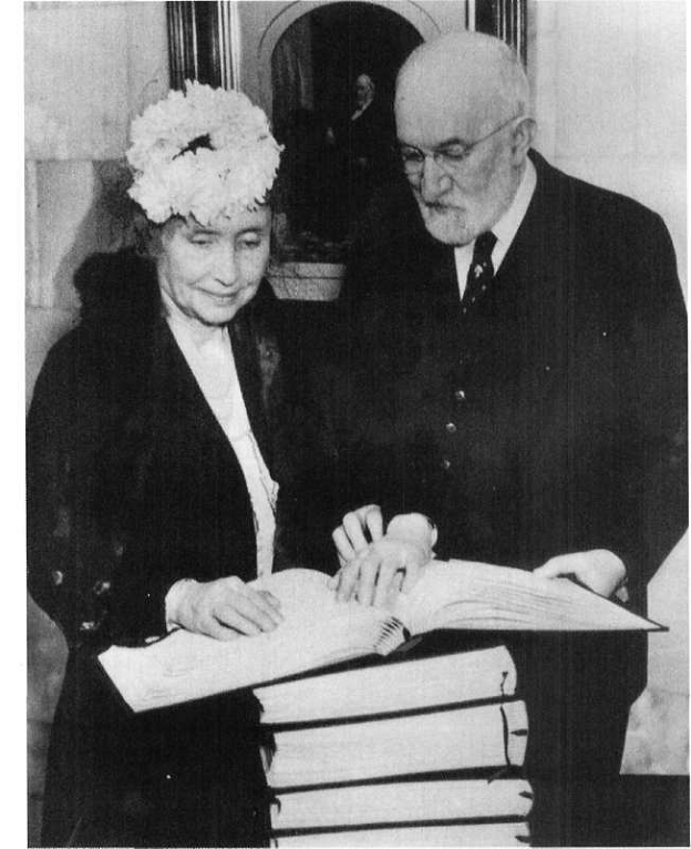 President Heber J. Grant showing braille Book of Mormon to Helen Keller