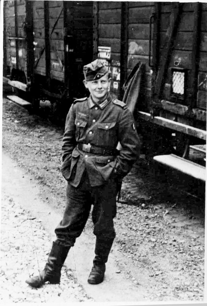 boy in uniform in front of train