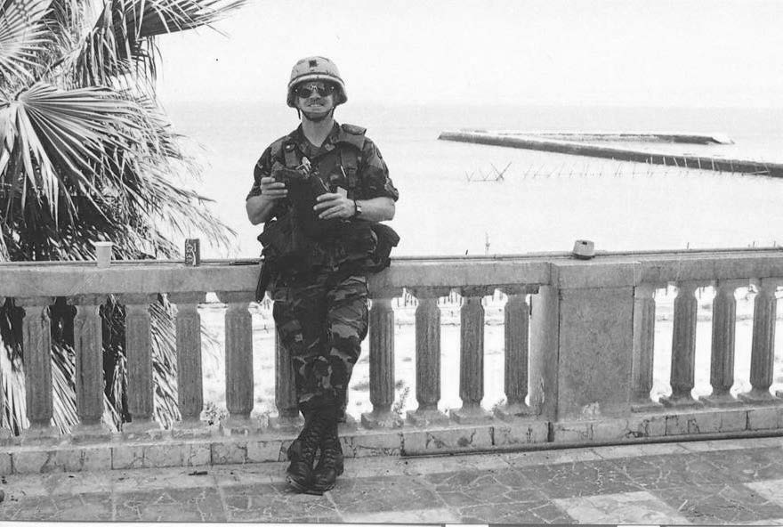 Combat artist Lieutenant Colonel Frank Thomas standing on Kuwaiti Emir’s Palace balcony on March 26, 1991. Courtesy of Frank M. Thomas.