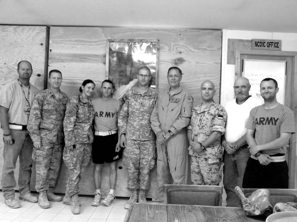 Kandahar Military Branch members on July 30, 2009. Left to right: Russell Greer, Cort Hacker (second counselor, branch presidency), Lilia Bullock, Donald Bullock, Carl Thomas, Gene Wikle (district president), Aleksei Juur (a member of the Estonian military and first counselor in the Estonia District presidency, who was serving for six months in Afghanistan), Dennis Britton (first counselor, branch presidency), and Greg Corbaley. Courtesy of Eugene J. Wikle.