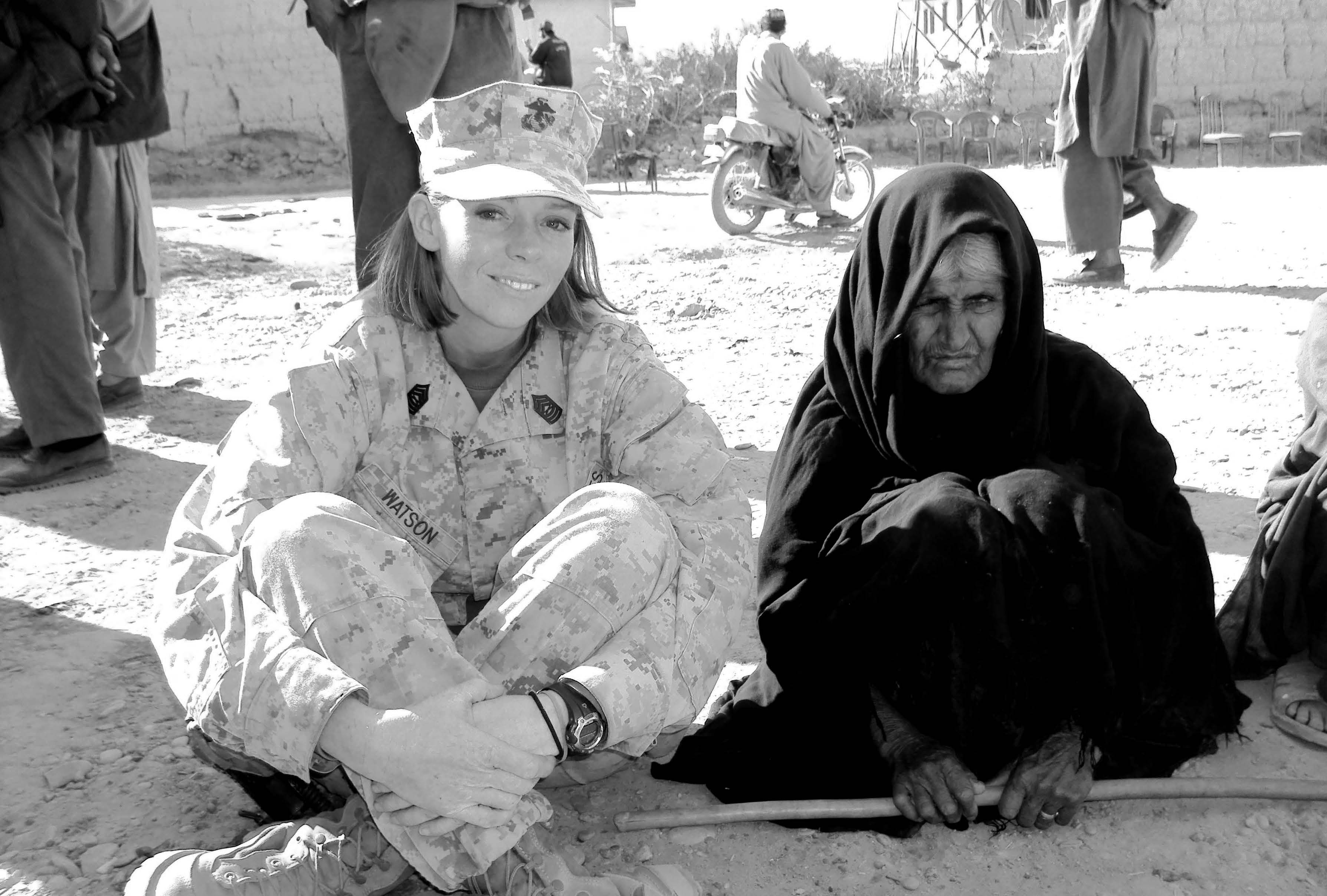 Marine Corps Master Sergeant Julia Watson, serving in Helmand Province, performing humanitarian service projects for the citizens of Afghanistan. Sister Watson and others completed an irrigation canal project for the Afghan woman sitting next to her. Courtesy of Eugene J. Wikle.