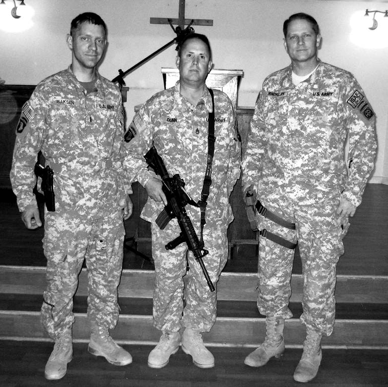Bagram Afghanistan Branch leadership. Left to right: Brother Isakson; Brother Dunn, elders quorum president; Brother Hinchcliff, district high councilor who was later called to serve as the branch president. They attended their meetings, spoke at the pulpit, and administered the sacrament while fully armed. Courtesy of Richard Belcher.