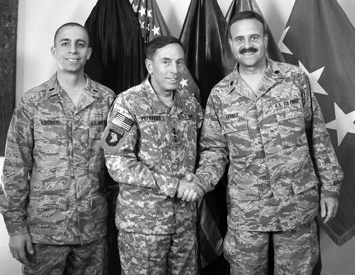Latter-day Saint father (Kurt Liechty, right) and son (Mike Liechty, left), who served at the same time in Afghanistan, are pictured with General David Petraeus, commander of the International Security Assistance Force, in February 2011. Courtesy of Eugene J. Wikle.