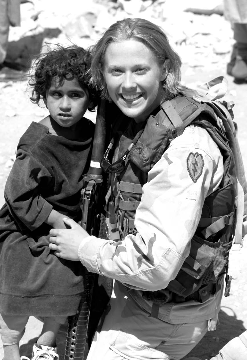 Utah Army National Guard soldier Jill Stevens, who served one year as Miss Utah, with an Afghan child. Courtesy of Jill Stevens.