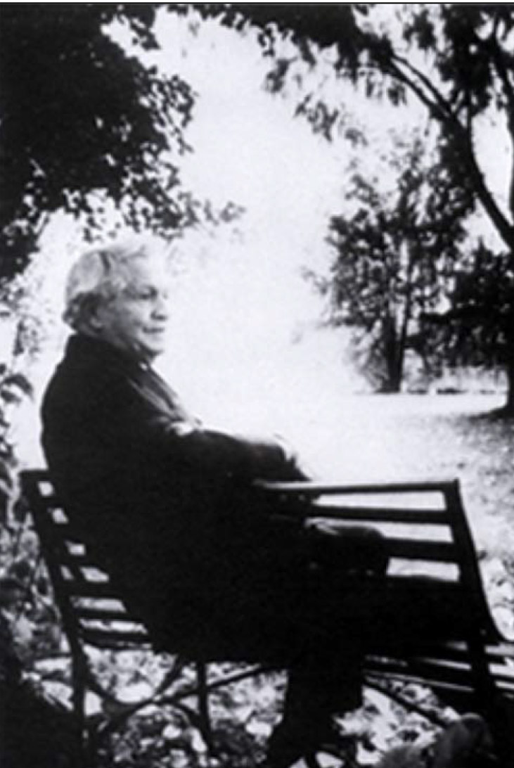 President David O. McKay sitting on a bench