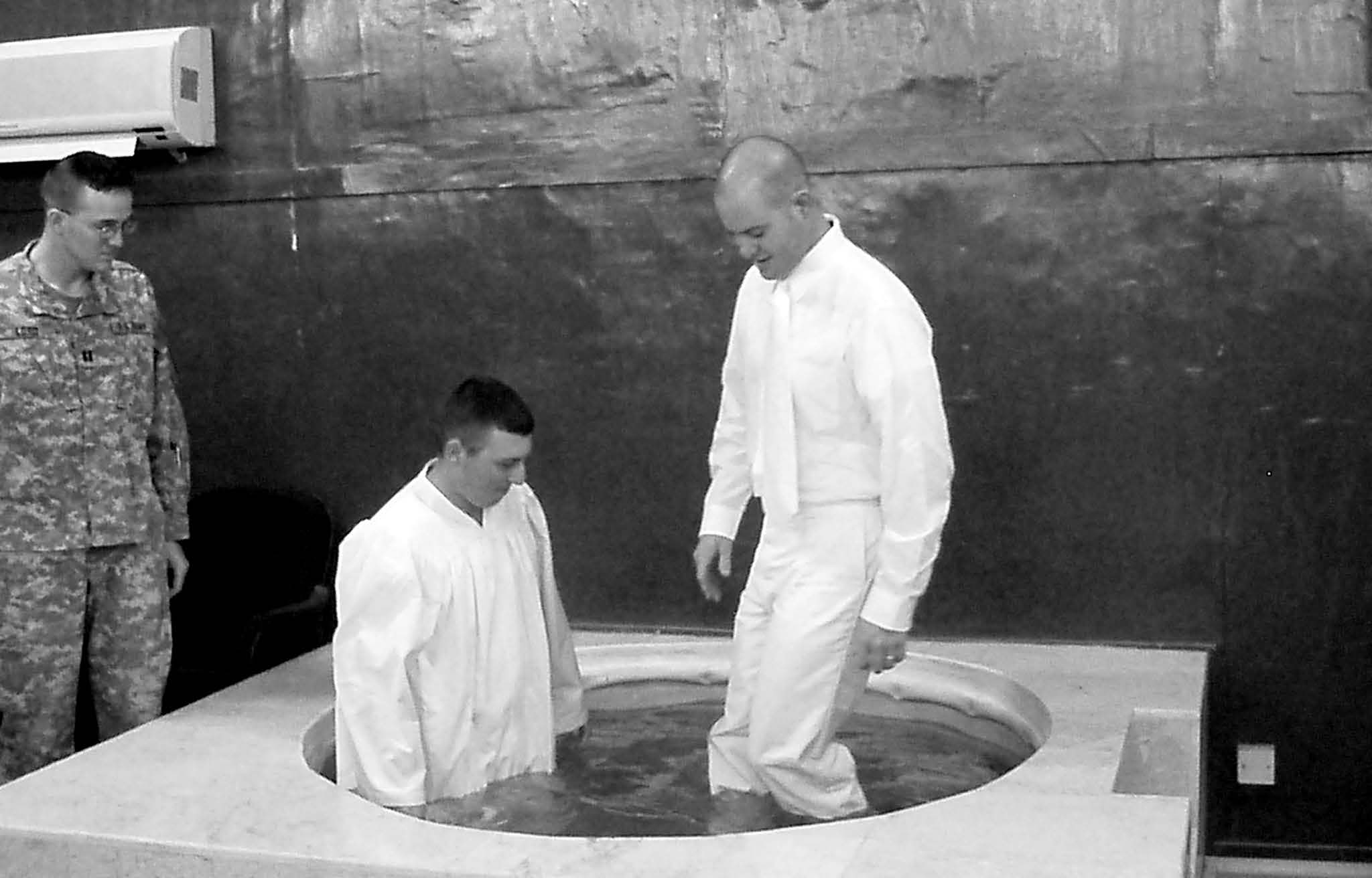 Johnathan Hayes and Ty Lamb prepare for a baptism in the 10th Mountain Division’s Warrior Chapel font at Camp Liberty, Baghdad, on July 12, 2006. Camp firemen filled the font prior to the service. Courtesy of Jon Petty.