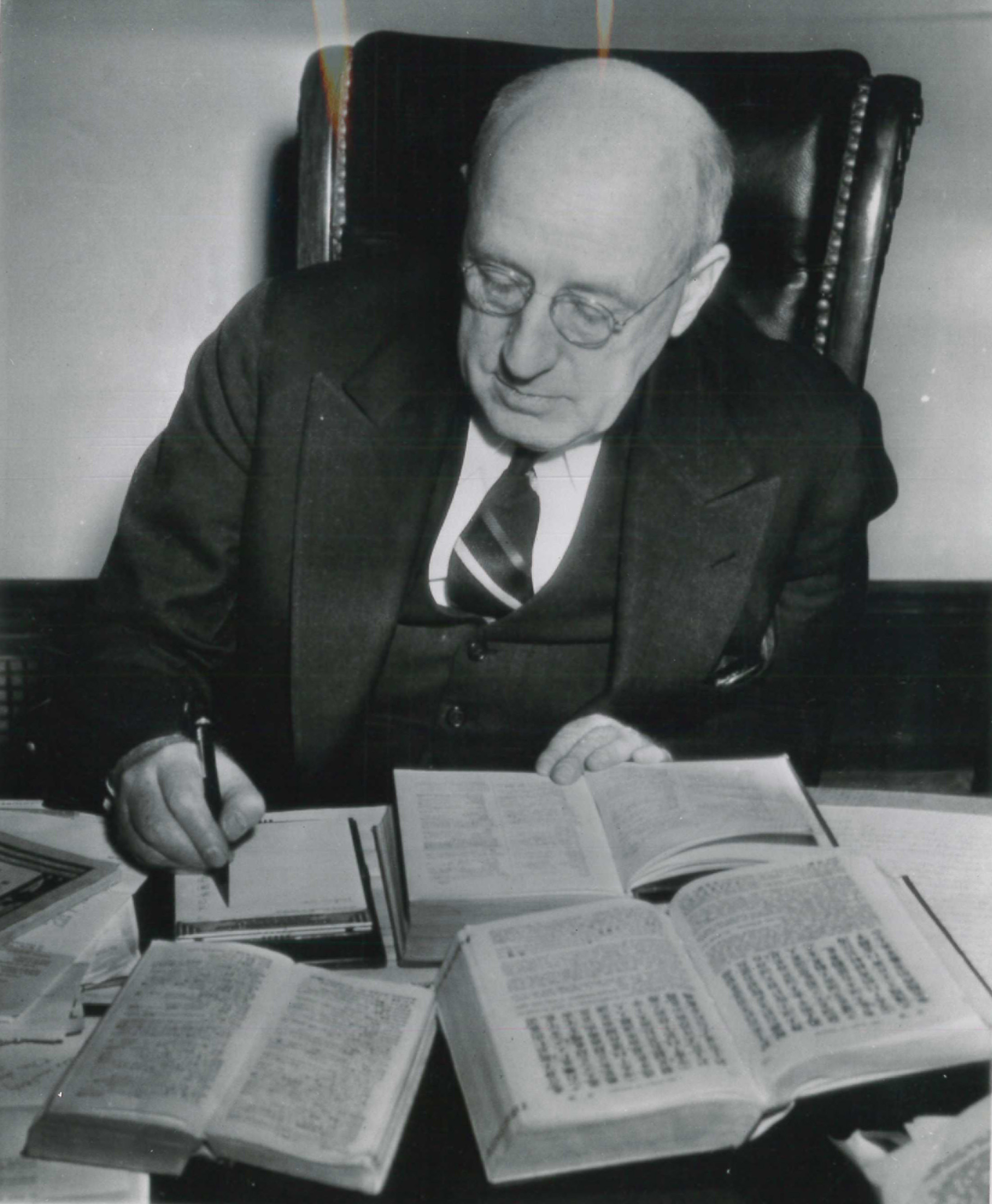 Senator Elbert Thomas, a former missionary to Japan, working on the translation of a script for a shortwave radio broadcast in Japanese beamed from the Pacific Coast to Japan, 11 January 1942. Before him on the desk is an English-Japanese dictionary and other reference books. AP Wire Photo.