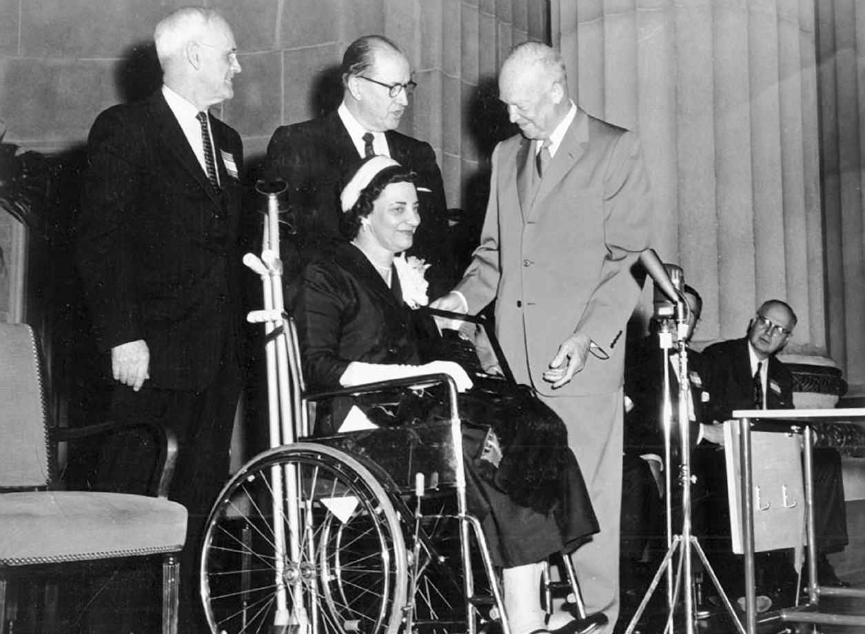 Senator Arthur Watkins, left, secretary of agriculture Ezra Taft Benson, center, and President Dwight D. Eisenhower, right, greet an unidentified woman at a speaking engagement, September 1958. Utah State Historical Society.