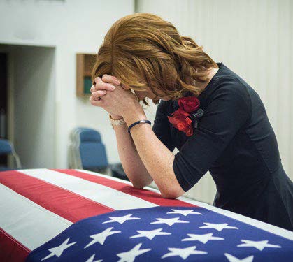 Jennie Taylor at the casket of her husband, Major Brent Taylor, who was killed in Afghanistan, in November 2018. Courtesy of Westbroek Studios