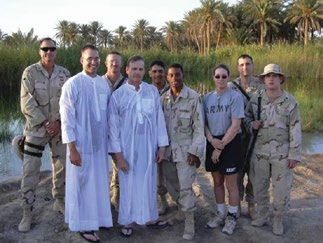 The 3rd Armored Cavalry Regiment’s Latter-day Saint service member’s group is shown after performing a baptism for Sergeant Kevin Wood (center) in an oasis in western Iraq’s Al Anbar province. Staff Sergeant Tony Bertolino (far left) was later killed by sniper fire during a convoy traveling toward the Syrian border. Courtesy of BYU Saints at War Project.