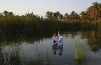 A Latter-day Saint service member of the 3rd Armored Cavalry Regiment baptizes Sergeant Kevin Wood in an oasis in Iraq’s Al Anbar province. Courtesy of BYU Saints at War Project.