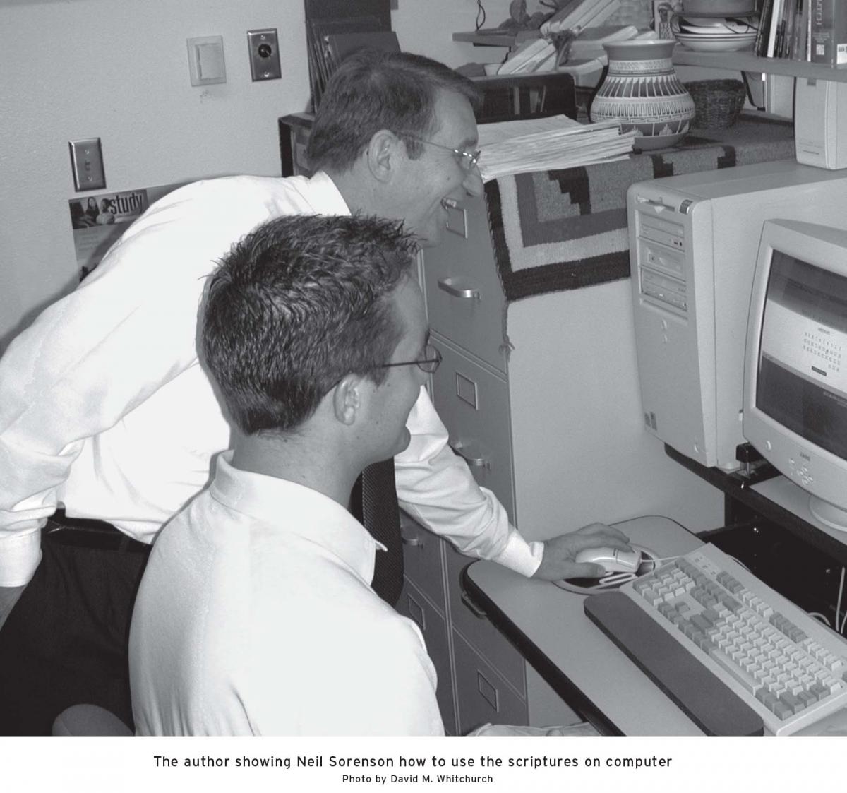 Two men studying on a computer