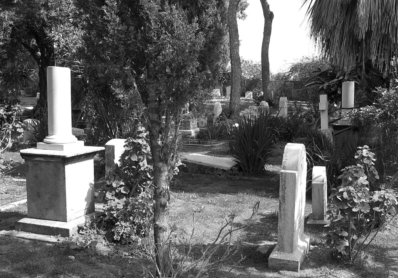 German Colony cemetery, Haifa, Israel. The grave marker of Elder Adolf Haag is on the left. On the far right, under the palm tree, is the matching grave marker of Elder John A. Clark.