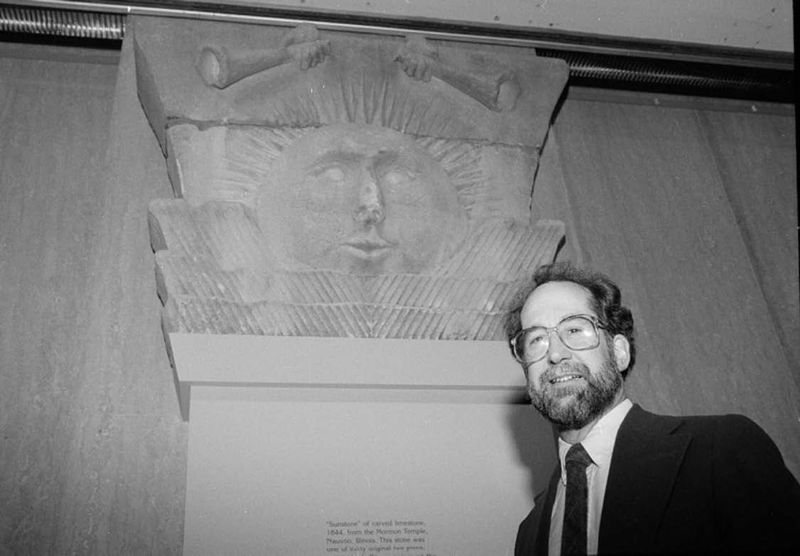 Figure 14. Richard E. Ahlborn, Community Life curator for the Smithsonian’s National Museum of American History, by the Nauvoo Temple sunstone exhibit. Ahlborn played a leading role in securing the sunstone for the museum. Photo by Rick Vargas. National Museum of American History, 1990.