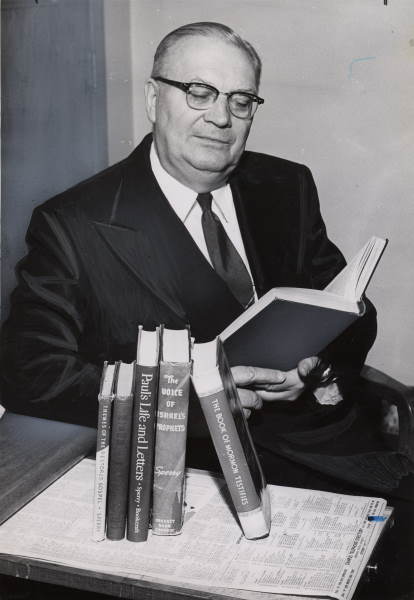 photo of sidney b sperry reading at his desk
