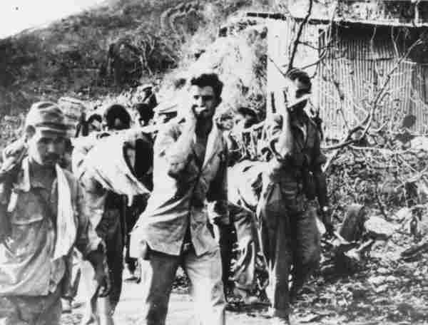 photo of american servicemen carrying two of their dead