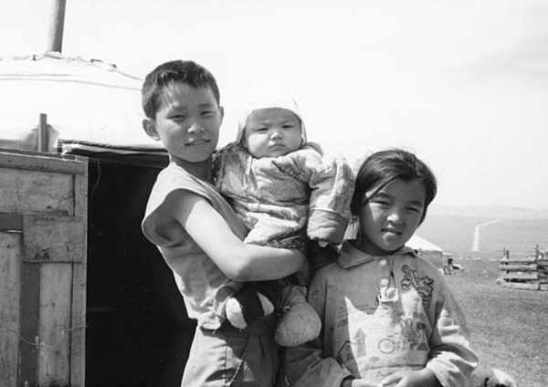 photo of three children outside of a ger
