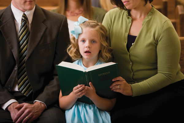 photo of a young girl singing in church