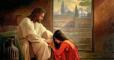 woman kneeling at Jesus's feet