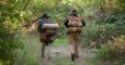 early missionaries walking in a forest